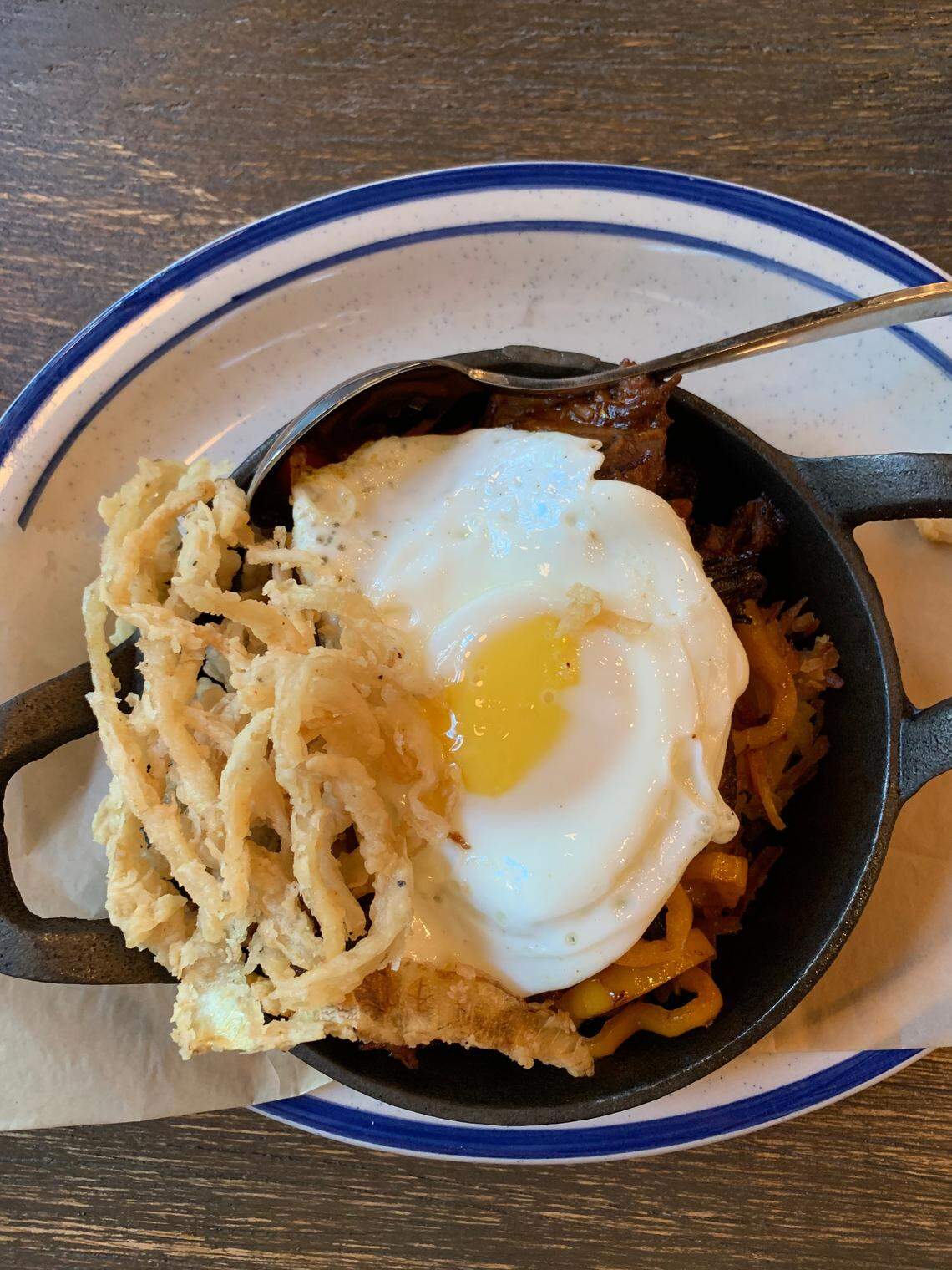 Brisket hash from Porch restaurant in Louisville features spicy BBQ sauce, veggie sweet pepper, fried egg for $13.