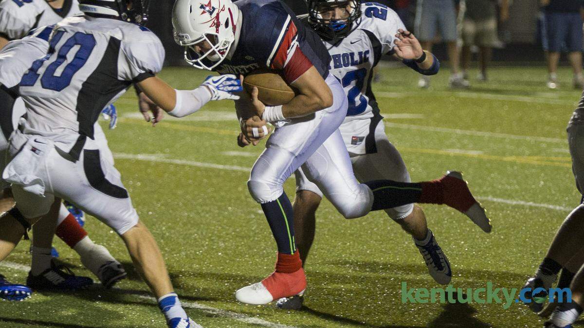 Lafayette's Walker Wood scores the go ahead touch down as Lafayette comes from behind in the final minutes and scores two touchdowns to win against Lexington Catholic.   Lafayette hosted Lexington Catholic on Friday September 5, 2014 in Lexington, Ky.  Photo by Mark Mahan