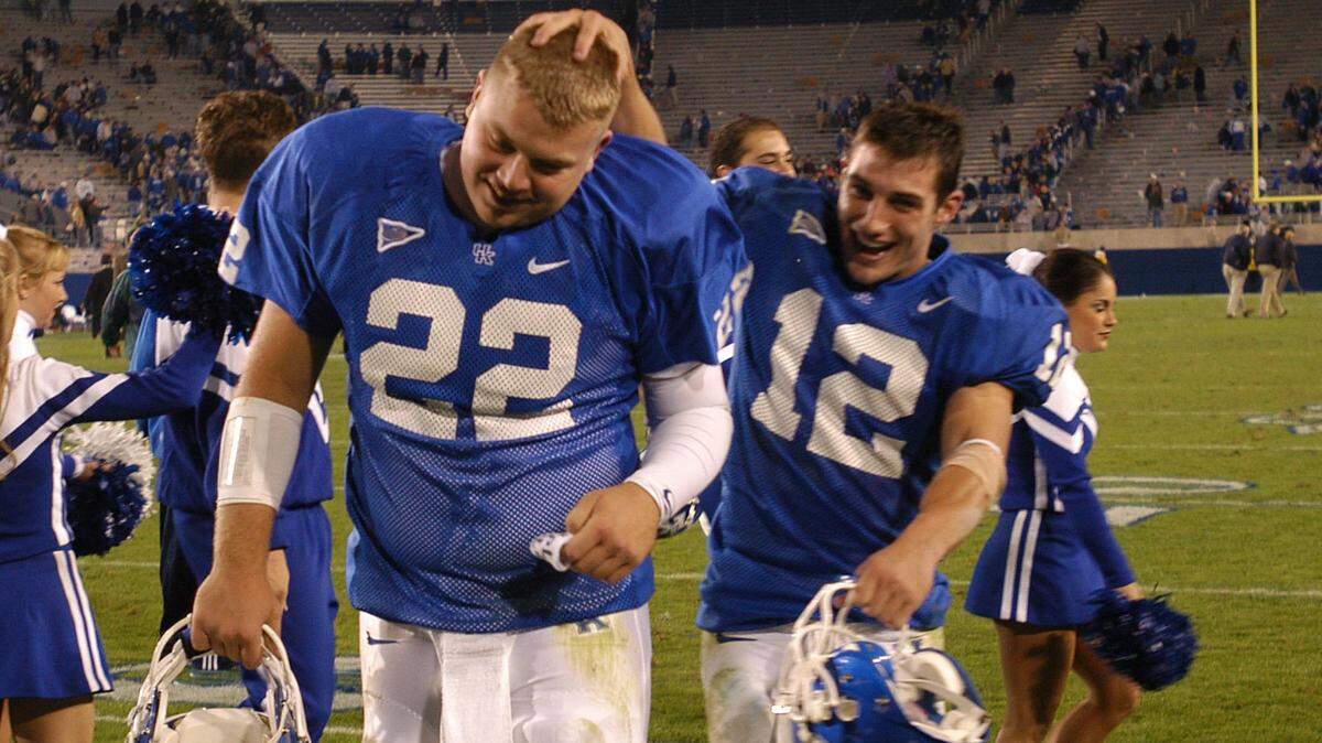 Jared Lorenzen got a pat on the head from wide receiver Derek Abney after UK beat Ohio University on Homecoming in 2003.