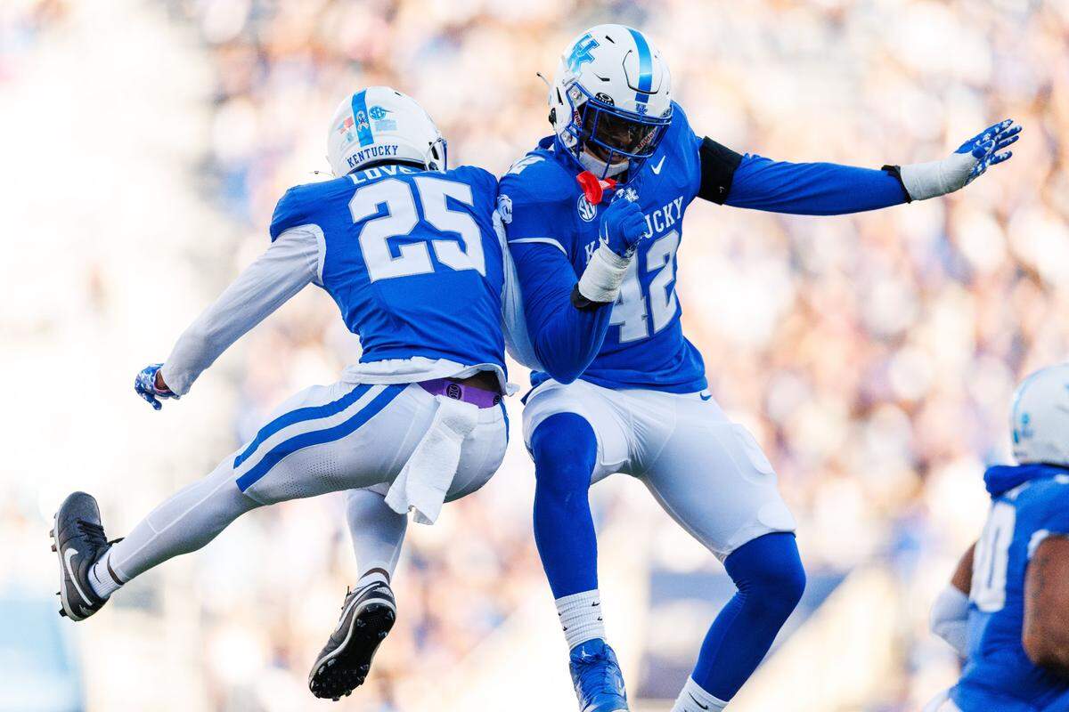 Nov 16, 2024; Lexington, Kentucky, USA; Kentucky Wildcats defensive back Jordan Lovett (25) celebrates with linebacker Tyreese Fearbry (42) after he intercepted a pass during the second quarter against the Murray State Racers at Kroger Field. Mandatory Credit: Jordan Prather-Imagn Images