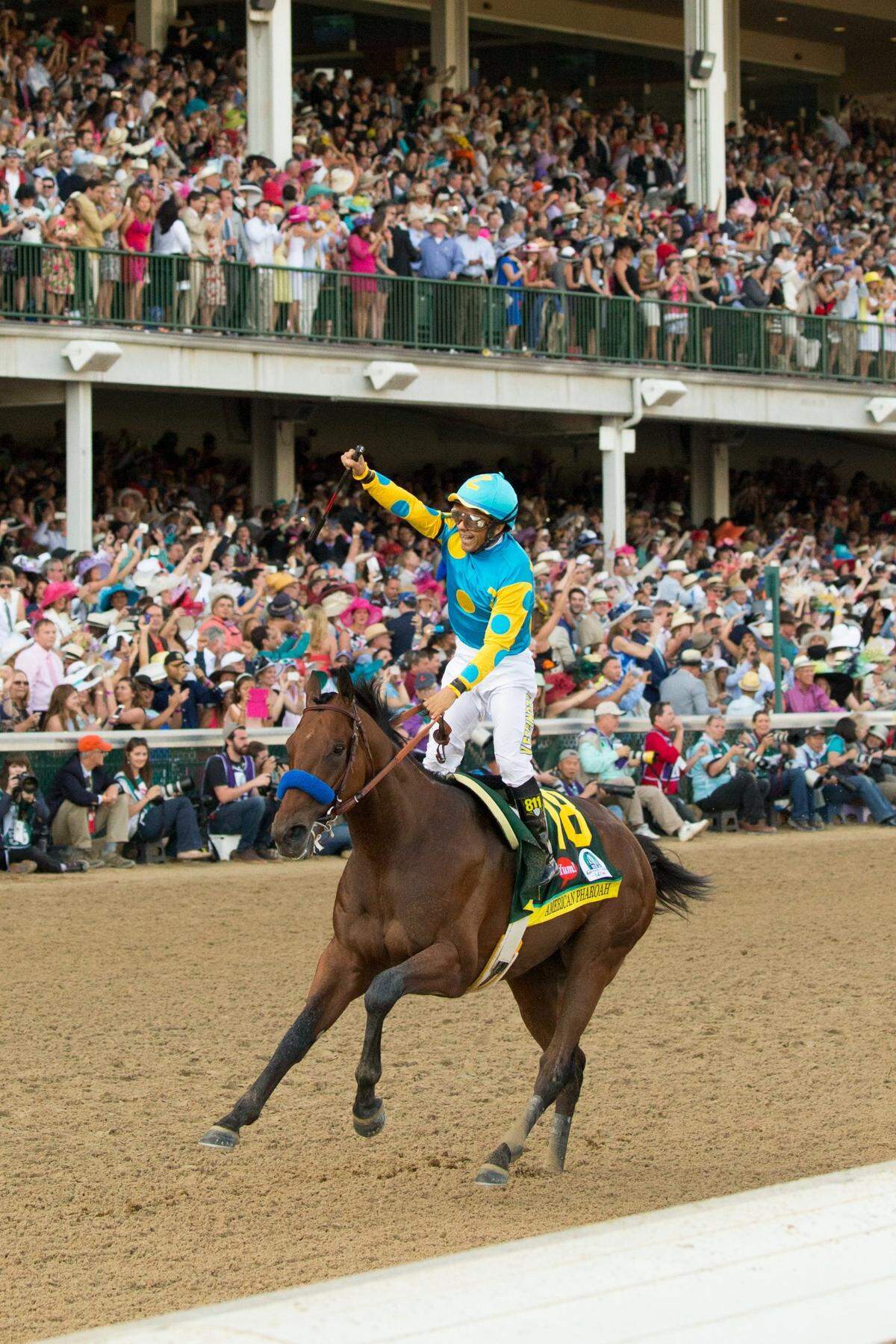 American Pharoah, ridden by Victor Espinoza, wins the 2015 Kentucky Derby at Churchill Downs in Louisville in front of a record crowd of 170,513. American Pharoah went on to win the Triple Crown, a high point for a sport tarnished by scandal in recent years.