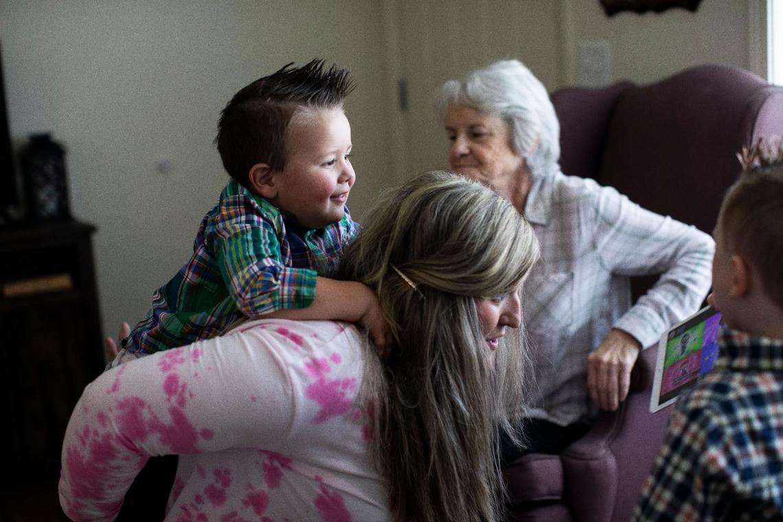 Megan Simpson gives her son Sawyer, 2, a ride on her back before heading to the playground in Barbourville, Ky., Friday, May 7, 2021. Being there for her kids is one of Megan’s main motivations to get clean and move past addiction. Currently Megan’s twin sister Morgan is caring for her three sons, but she is scheduled to get custody of them in Spring of 2022.