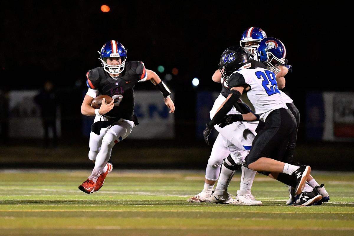 Christian Academy-Louisville’s Cole Hodge (2) runs through an opening in the Lexington Catholic defense during Friday’s playoff game.