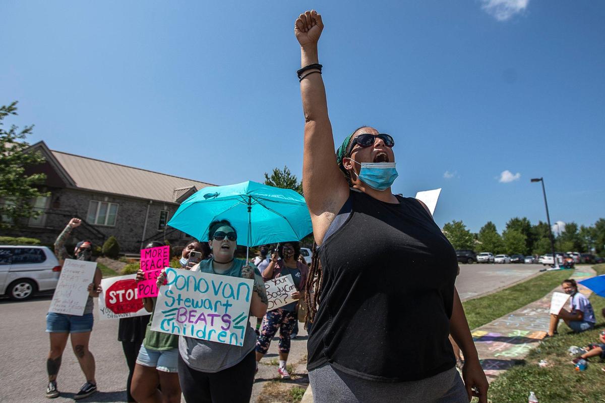 Sarah Williams protests outside the Fraternal Order of Police Bluegrass Lodge 4 in Lexington, Ky., before Former Lexington police chaplain Donovan Stewart speaks on Thursday, July 9, 2020. Stewart has retired from the police department and filed a defamation lawsuit against Sarah Williams and April Taylor and 10 other unnamed ÒJohn Does.Ó
