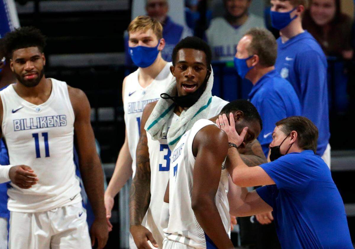 Saint Louis forward Hasahn French (11) and guard Javonte Perkins (3) watched head coach Travis Ford congratulate guard Javonte Perkins (3) after the Billikens beat ACC foe North Carolina State 80-69 this month.