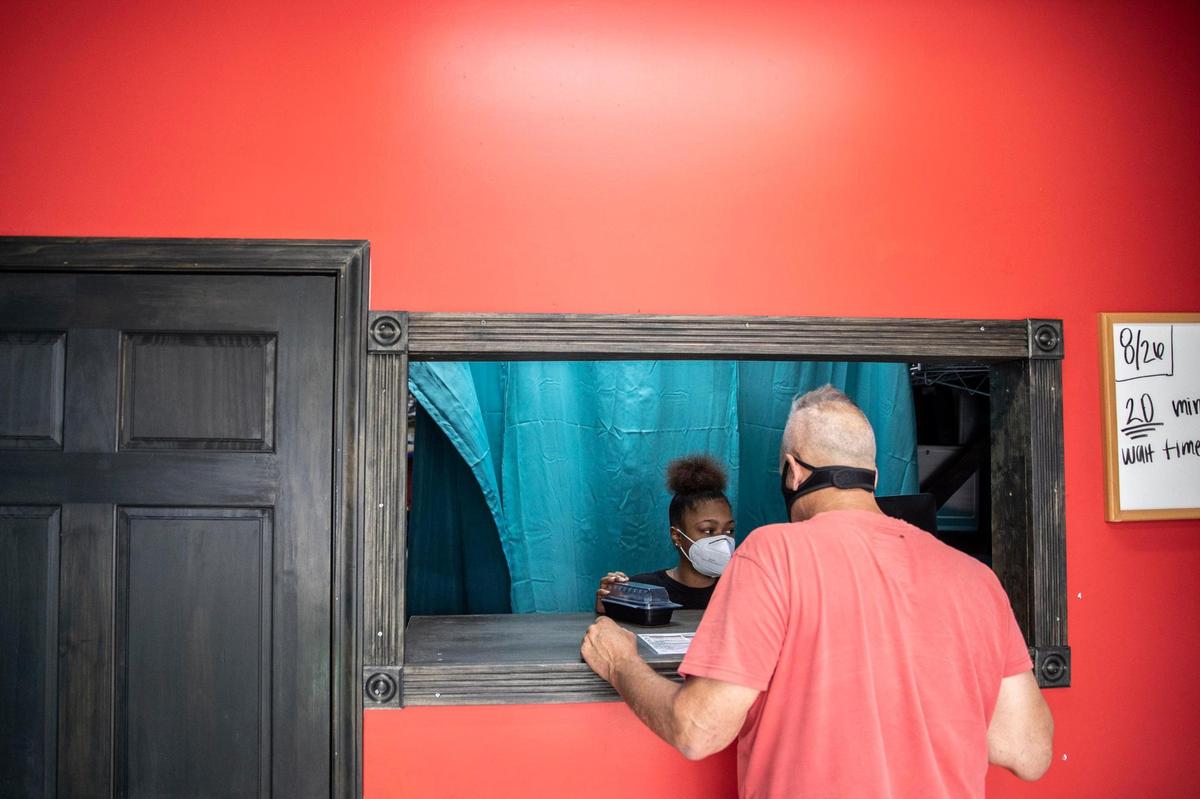 Nick Salvi, of Cream Ridge, N.J., places an order at Seafood Lady at 833 Georgetown Street in Lexington, Ky., on Thursday, Aug. 28, 2020. The carryout restaurant features Cajun-style seafood boils with lobster, oysters, crabs, shrimp, fish, Southern seafood, plus po’boys and more.
