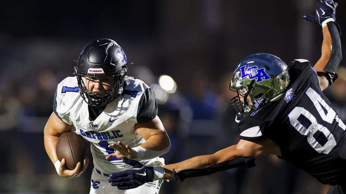 Lexington Catholic's Brady Wasik (1) breaks past the tackle of Lexington Christian's Logan Mays (84) during LCA's 28-21 win over Lexington Catholic during a high school football game, Friday, Sept. 19, 2025 at Lexington Christian Academy in Lexington, Ky.