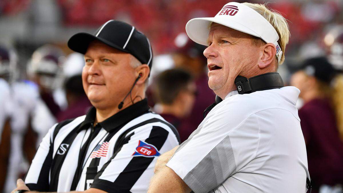 Eastern Kentucky Coach Walt Wells, right, leads a football program at a school that is trying to form a new league that will move from the FCS to the FBS.