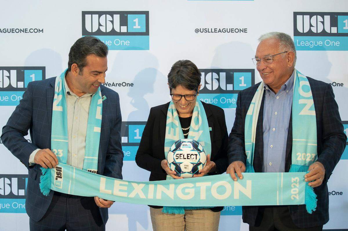 From left, Stephen Dawahare, Lexington Mayor Linda Gorton and William J. Shively pose for photos after the announcement last fall that the city is being awarded an expansion pro soccer franchise in USL League One.