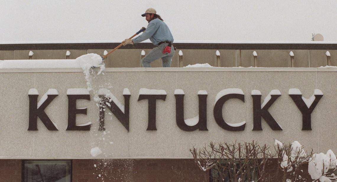 Bob Davis, with Brett Construction Company, shovels snow off the office roof at Kentucky Eagle Beer Inc. at 475 Angliana Ave. as the snow storm continues on Friday Feburary 6, 1998. The warehouse roof collapsed at the beer distibutor. They were trying to get the snow off the office roof before it collapsed as well. There was heavy damage to the building and several trucks inside.
