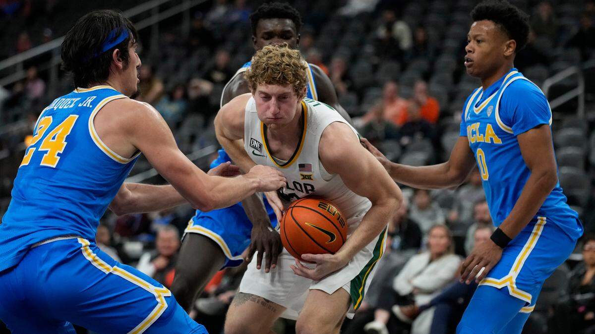 Baylor’s Caleb Lohner, center, is surrounded by UCLA’s Jaime Jaquez Jr., left, and Jaylen Clark, right, during their Nov. 20 game. UCLA has won six straight since its 80-75 loss to the Bears.