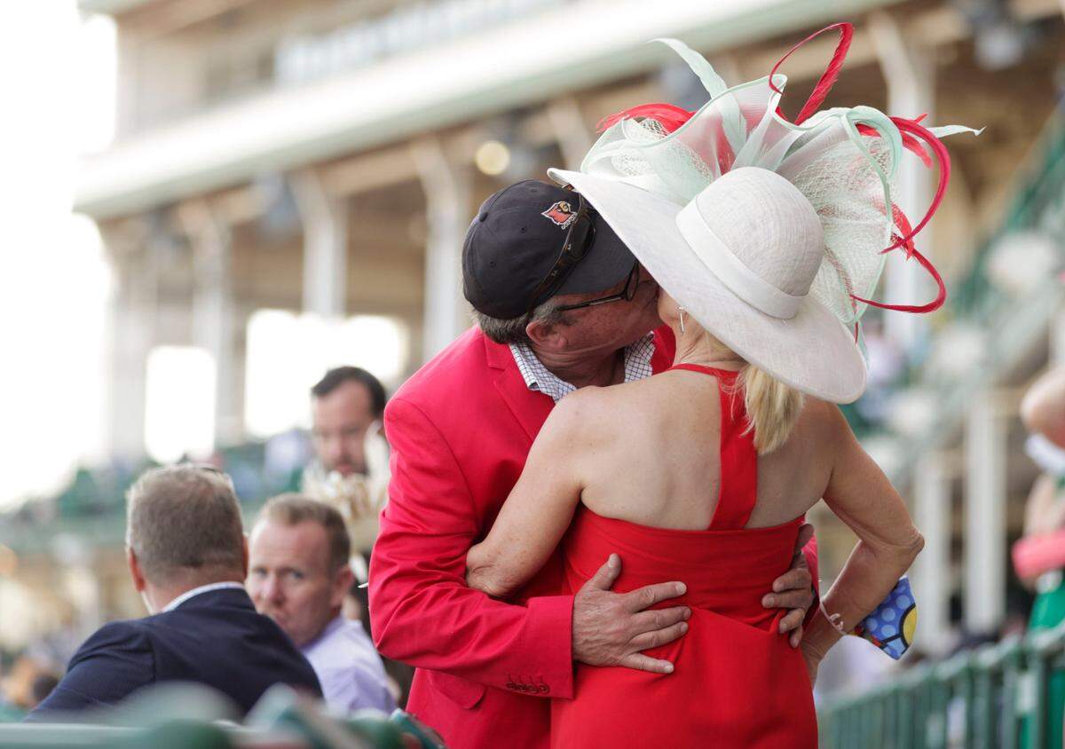 Jeff Flatt kisses his wife Sandy at Churchill Downs in Louisville, Ky., Saturday, May 1, 2021. They are celebrating 25 years of marriage.