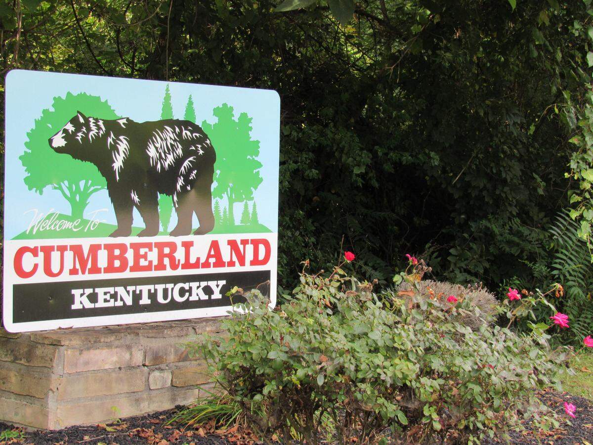 Signs on streets into Cumberland, in Harlan County, include art of black bears because they are common in the area.