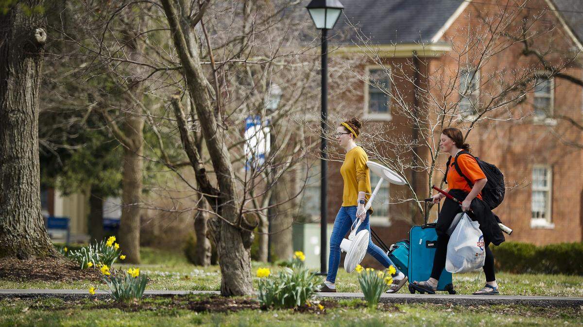 Berea College sophomores Veronica Mauratic, of Somerset, Ky., left, and Jessica Beisecker, of Great Falls, Mont., carry belongings out of their residence halls at Berea College in Berea in March. The College ceased on-campus activities by the end of the day on Friday out of concern over coronavirus. The majority of Berea’s students moved out on Saturday.