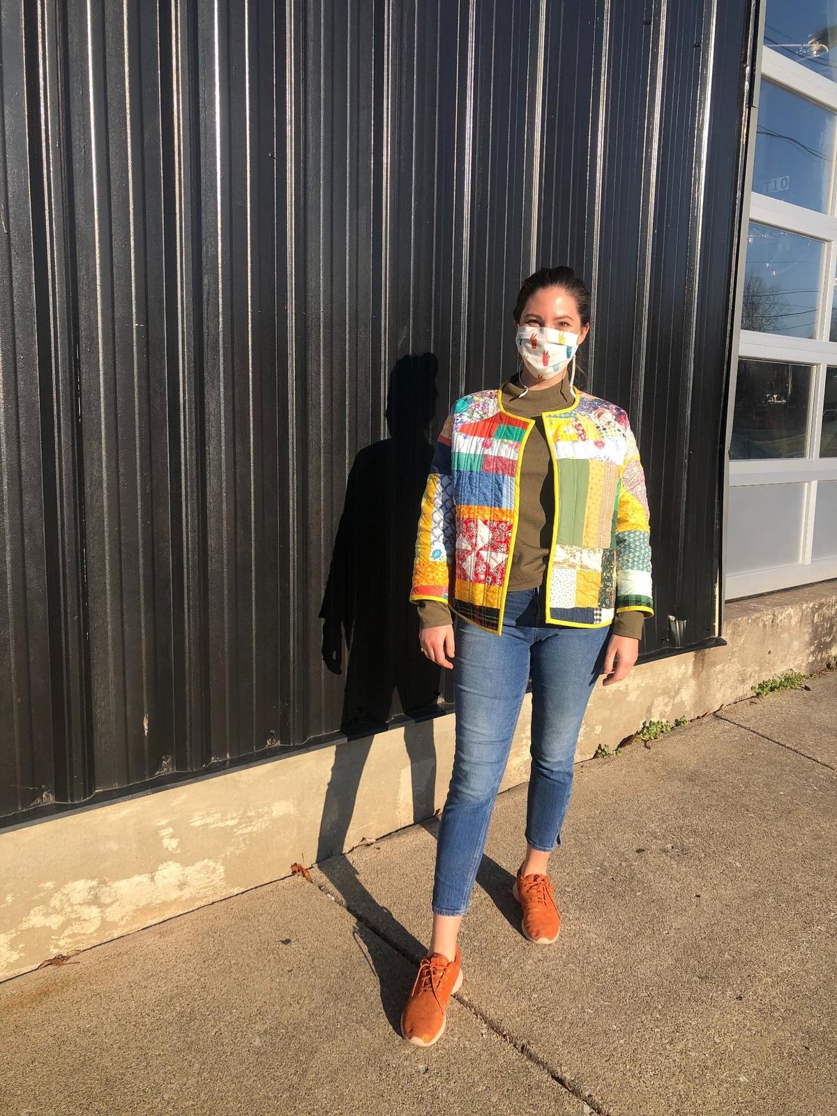 Hannah Allen poses with one a quilted jacket she made out of masks during quarantine. She will be working in the Department of Finance. Photo courtesy of Hannah Allen.