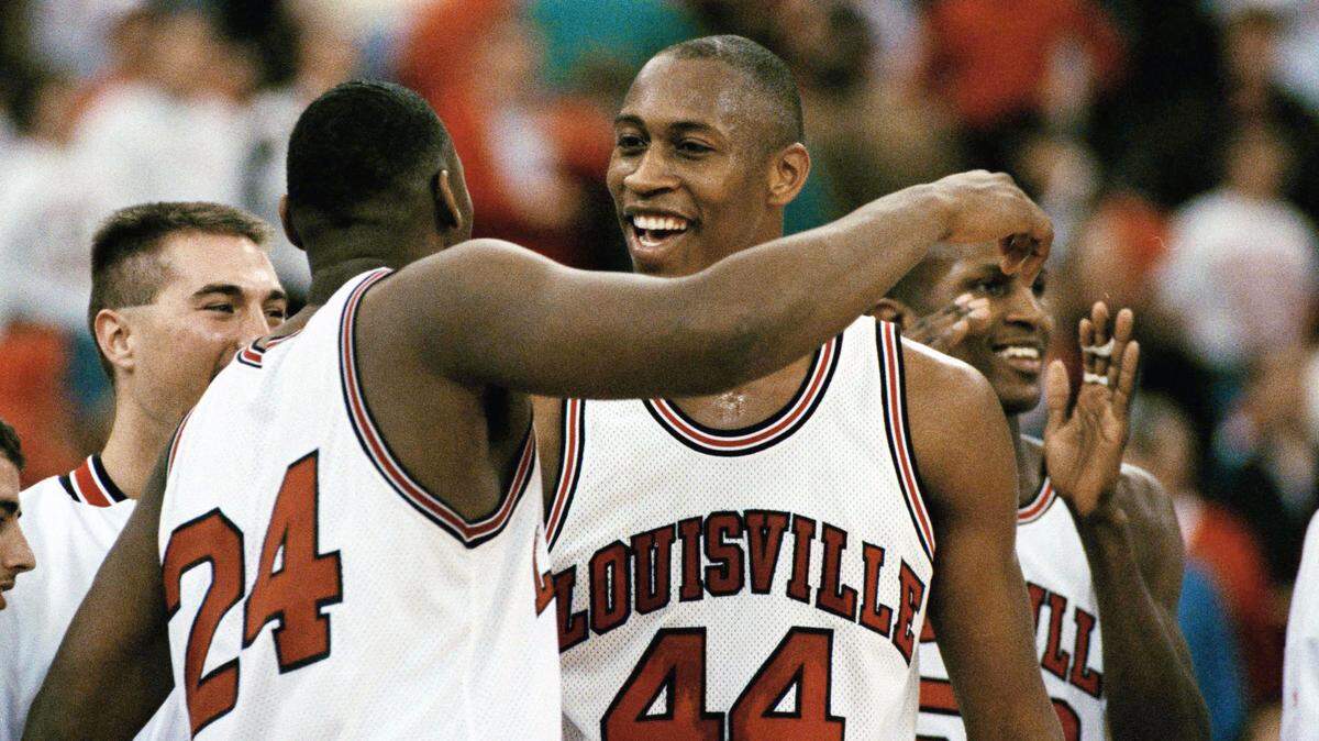 Clifford Rozier (44) celebrated Louisville's 78-63 victory over Oklahoma State with teammate Troy Smith (24) in the final minutes of their NCAA Midwest Regional game in the Hoosier Dome in Indianapolis, on March 22, 1993. Rozier died Friday after suffering a heart attack, according to a social media post by a family member.