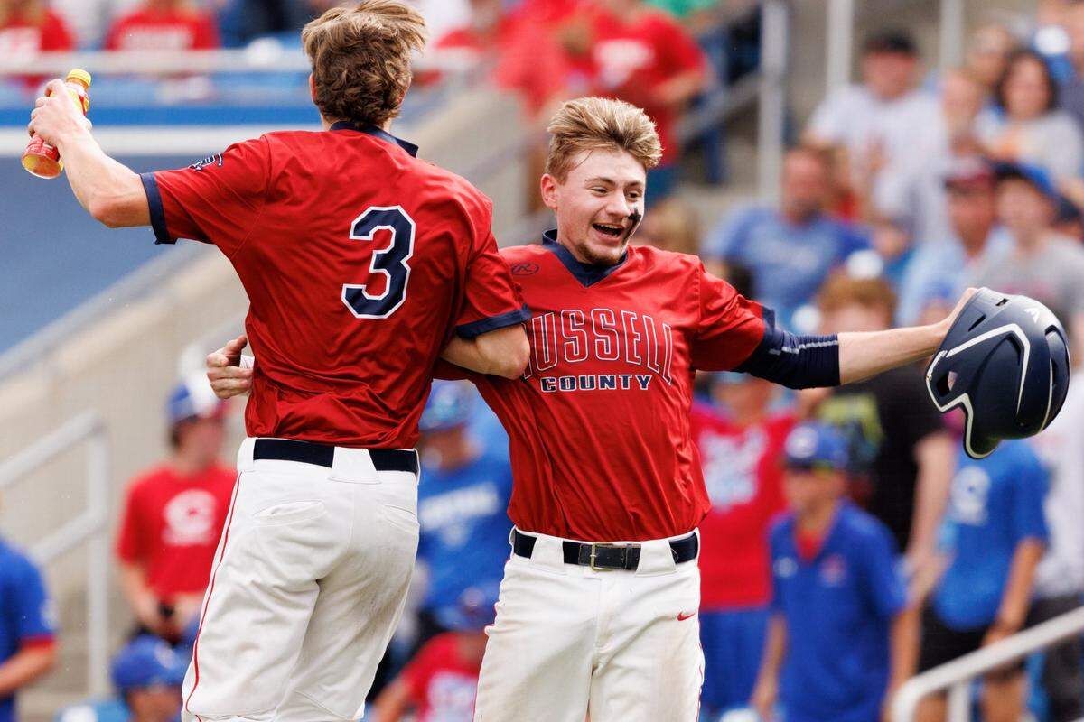 Russell County’s Alex Reynolds, right, celebrates with Trace Stringer after Reynolds scored the Lakers’ second run in a 2-1 victory over Madison Central at Kentucky Proud Park on Thursday night.