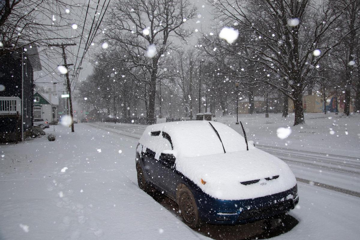 Snow accumulates on a vehicle parked near Duncan Park in Lexington, Ky., Thursday, January 6, 2022.