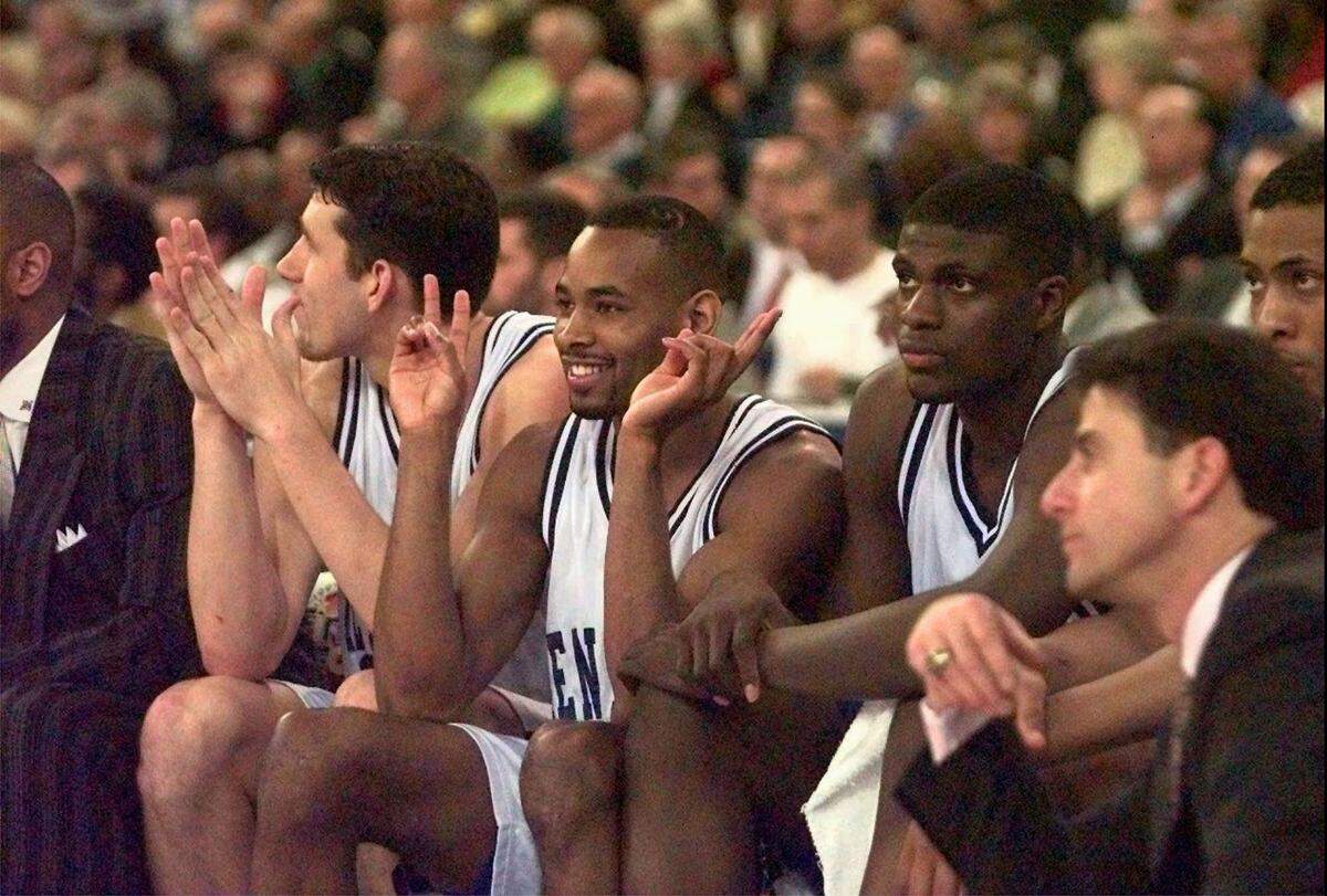 Kentucky’s Scott Padgett, left, Derek Anderson, center, and Nazr Mohammed, right, and UK Coach Rick Pitino during the Wildcats’ 66-58 win over Minnesota in the 1997 Final Four.