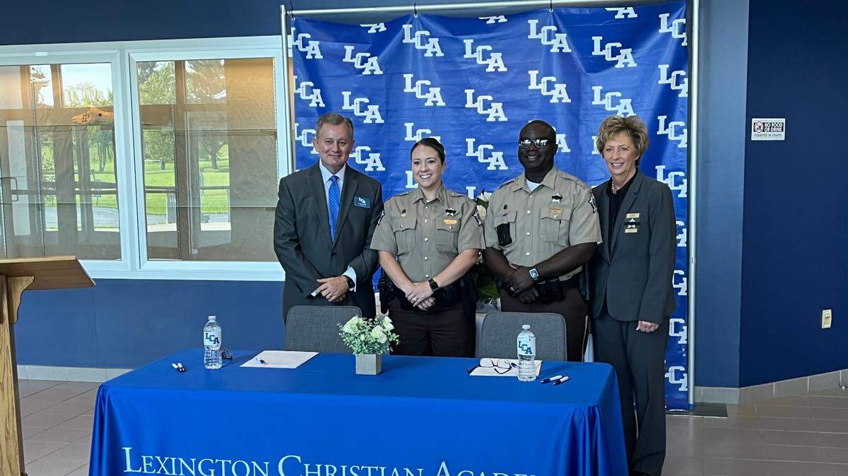 (From left) Dr. Scott Wells, Deputy Brittany Whitcomb, Chaplain Anthony Palmer and Sheriff Kathy Witt pose for a photo at a press conference at Lexington Christian Academy on May 19. The Fayette County Sheriff’s Office and LCA announced a partnership to put two school resource officers on campus next school year.