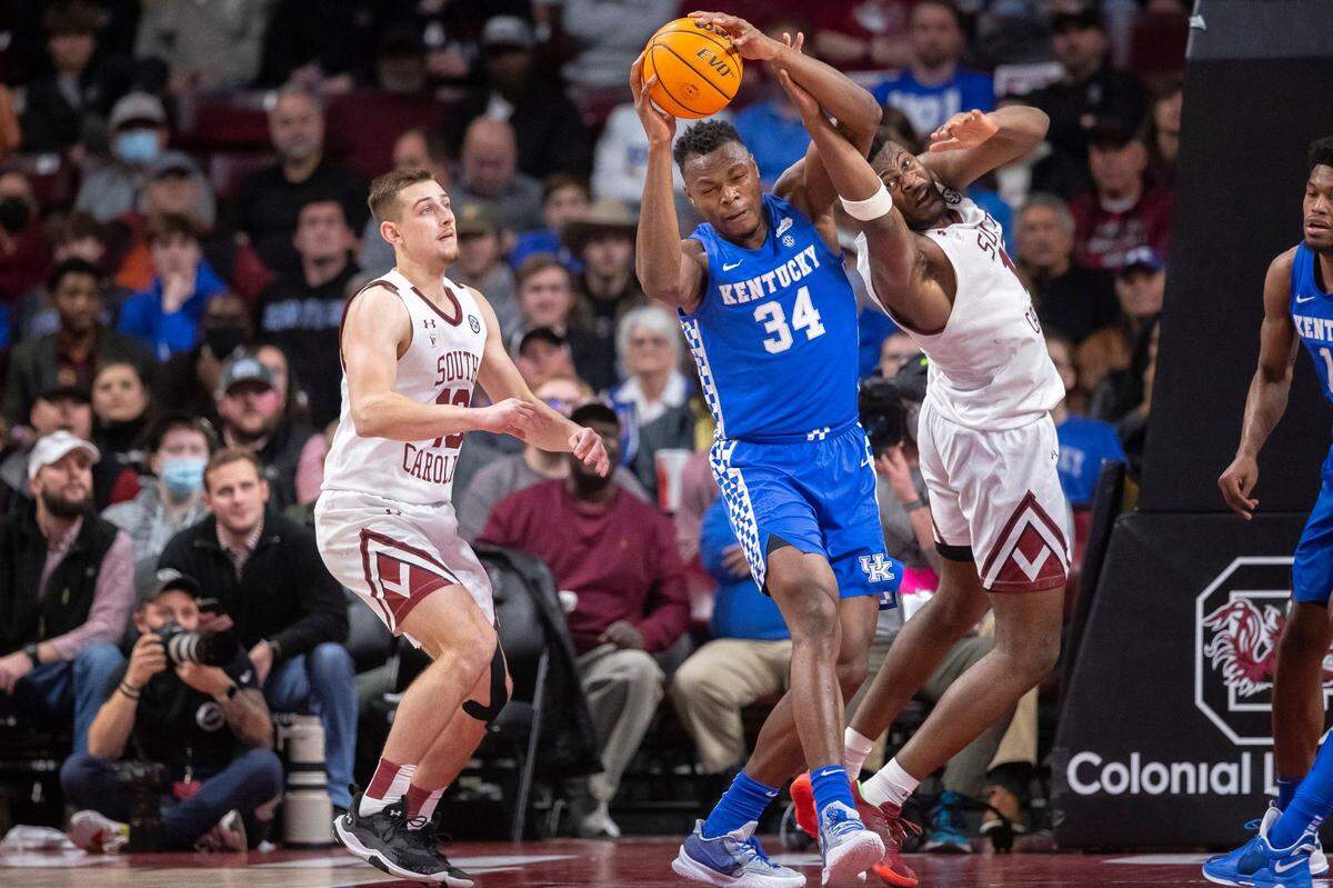 Kentucky’s Oscar Tshiebwe (34) wrestles a rebound from South Carolina’s Wildens Leveque (15) during Tuesday night’s game in Columbia, S.C. Tshiebwe finished with 18 points and 14 rebounds.