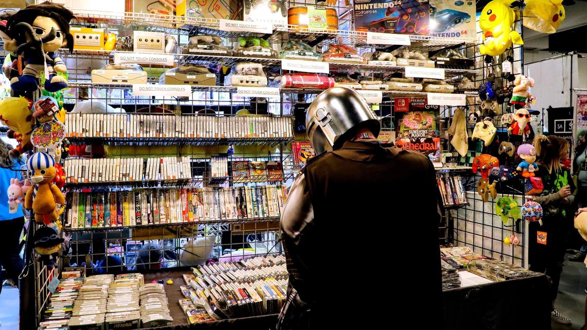 A patron looks over items for sale from a vendor on the exhibit floor during the 2022 Lexington Comic and Toy Convention at the Central Bank Center in Lexington, Ky. on Sunday, March 27, 2022.