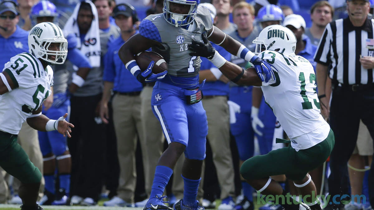 Kentucky Wildcats wide receiver Ryan Timmons (1) eluded the tackle of Ohio Bobcats cornerback Devin Jones (13) on a first half gain as Kentucky defeated  Ohio University 20-3 on Saturday September 6, 2014 in Lexington, Ky. Photo by Mark Cornelison | Staff