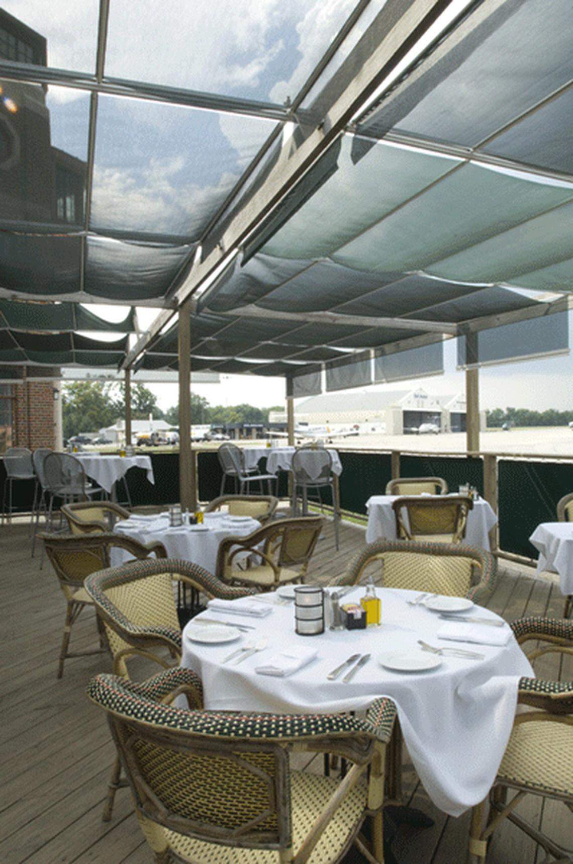 During the summer months at Bistro Le Relais, you can dine on the outdoor deck and watch the planes taxi down the Bowman Field runway.