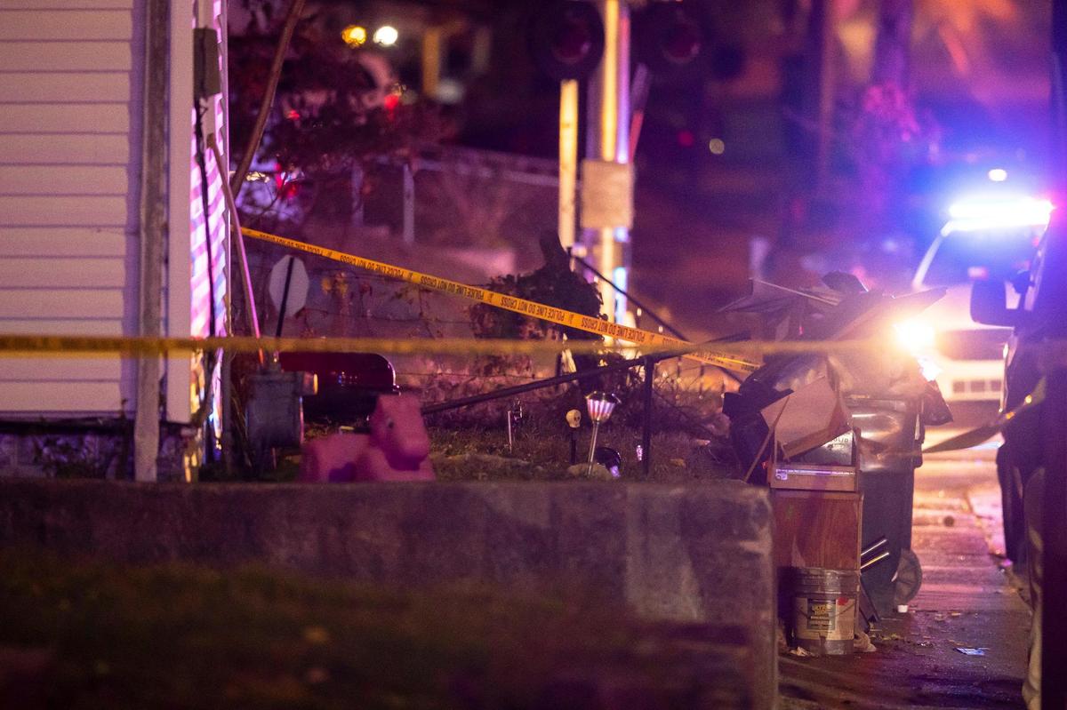 Members of law enforcement and the coroner’s office respond to a home in the 700 block of Maple Avenue in Lexington, Ky., on Tuesday, Oct. 25, 2022.