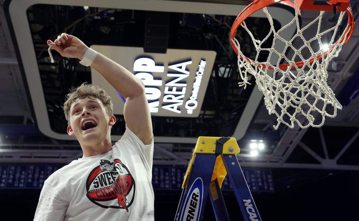 Clark County’s Aden Slone (4) displays a piece of the net after winning the championship of the UK Healthcare Boys’ Sweet 16 at Rupp Arena in Lexington, Ky., Saturday, March 19, 2022.