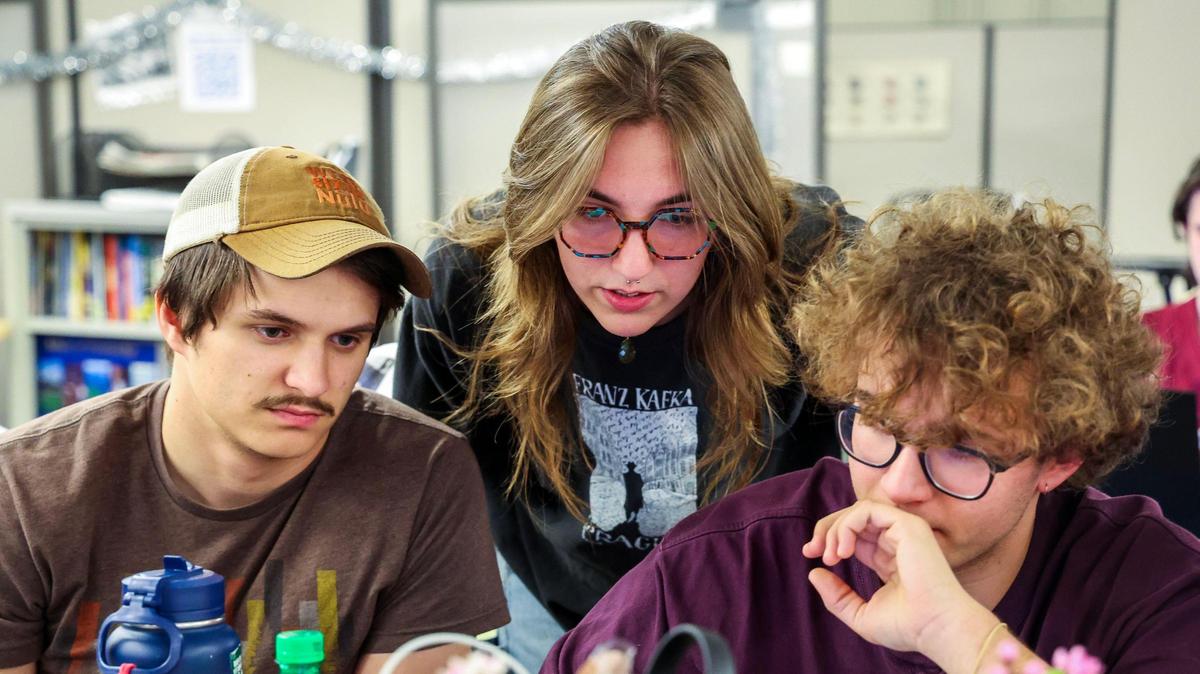 Kentucky Kernel Editor-in-Chief Abbey Cutrer, center, Photo Editor Matthew Mueller, left, and Assistant Photo Editor Christian Kantosky, right, look over images during a staff meeting, Monday, March 10, 2025 in the offices of the independent student newspaper of the University of Kentucky in Lexington, Ky.