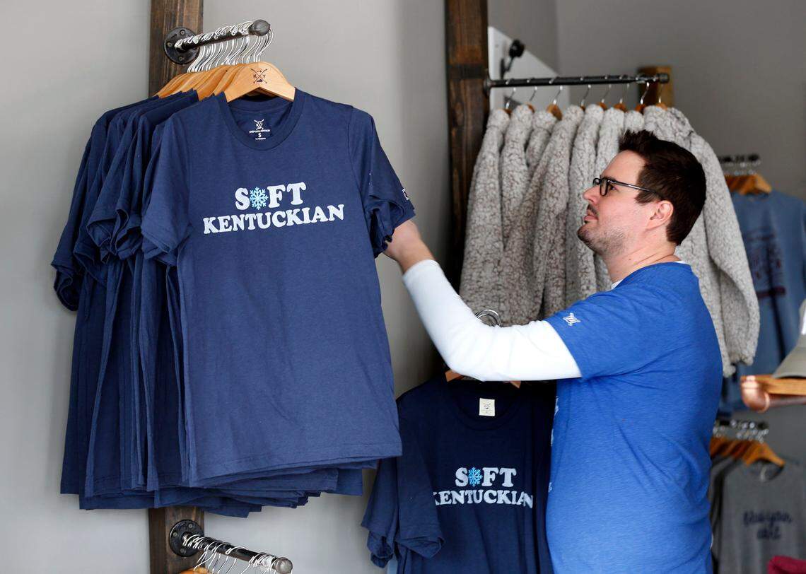 Adam Rahenkamp displayed some of the “Soft Kentuckian” t-shirts at Shop Local Kentucky Thursday, Jan. 31, 2019. This store, owned by Rick and Joni Paynter, decided to make the shirts in response to Governor Matt Bevin’s comment yesterday about frigid temps. A portion of the sale of the shirts will go to a local charity.
