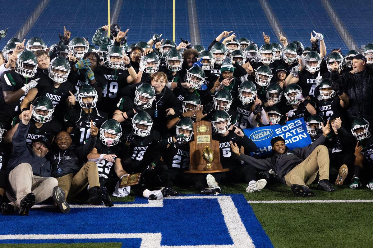 Trinity players celebrate the school’s 28th state championship in football.