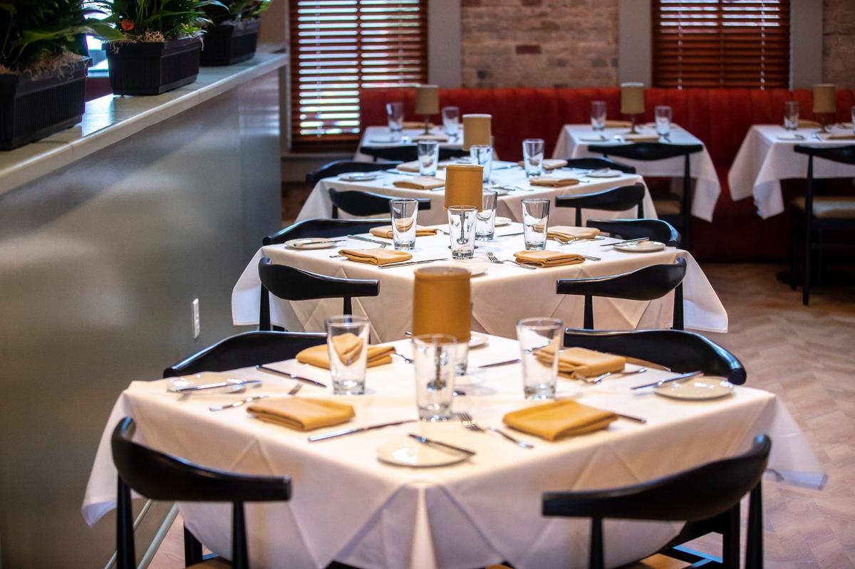 The two-story Vallozzi’s has different dining areas. Downstairs is a more casual dining area and bar, with a door that opens to an outdoor area with artificial grass, fire pits and bocce ball.