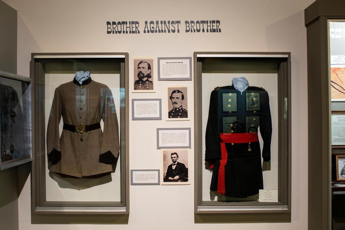 A display of Confederate and Union uniforms talks about brothers who join opposing sides during the Civil War at the Civil War Museum in Bardstown, Ky., Wednesday, July 7, 2021.