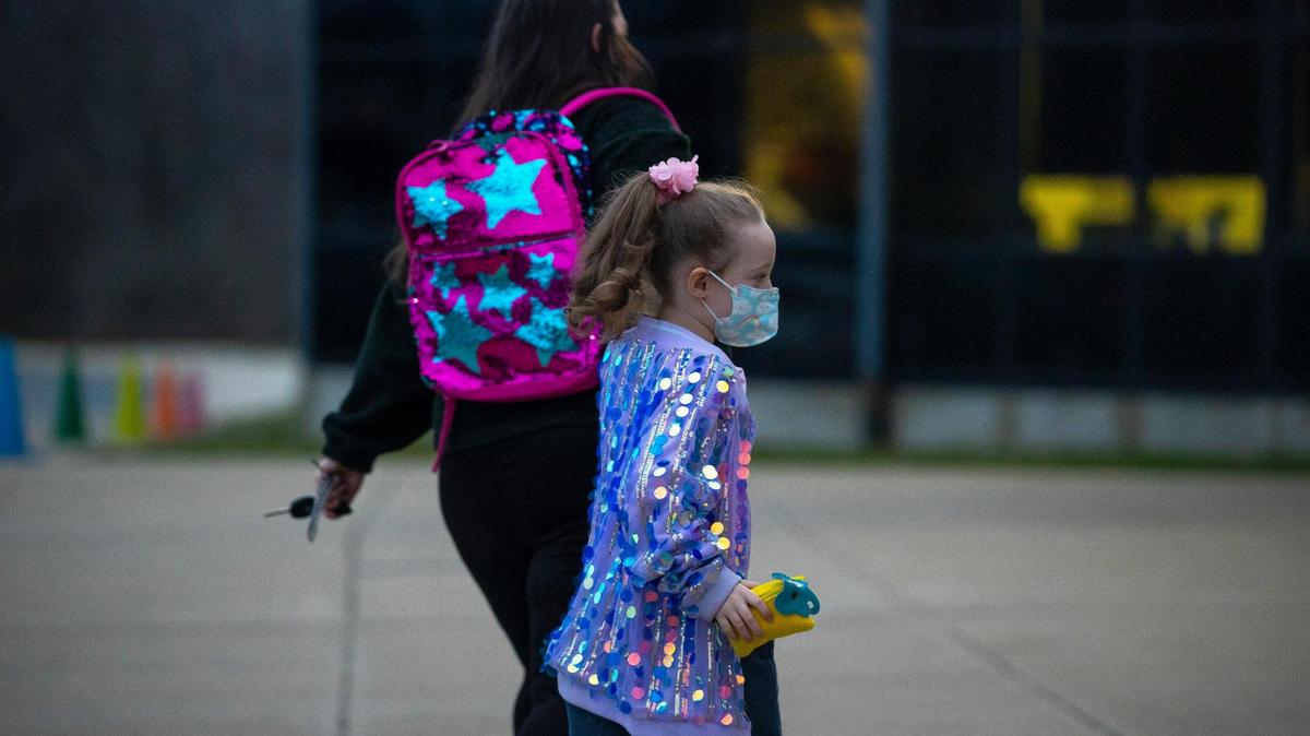 Madeline Graham walks her daughter, Ava Graham, 6, to the front entrance at Liberty Elementary School in Lexington, Ky., on Tuesday, March 15, 2022, the first day masks were optional in Fayette County Public Schools.