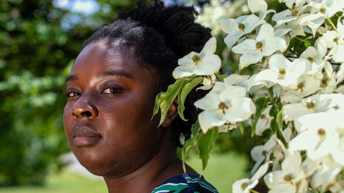 Ariel Arthur poses next to the blooming trees at The Arboretum on May 27, 2021.