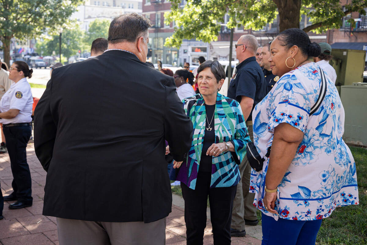 Mayor Linda Gorton, center shakes hands with Kenneth Armstrong, the comissioner of public safety in Lexington, during a community vigil on Tuesday, July 22, 2025, at Robert F. Stephens Courthouse Plaza in Lexington, Ky.
