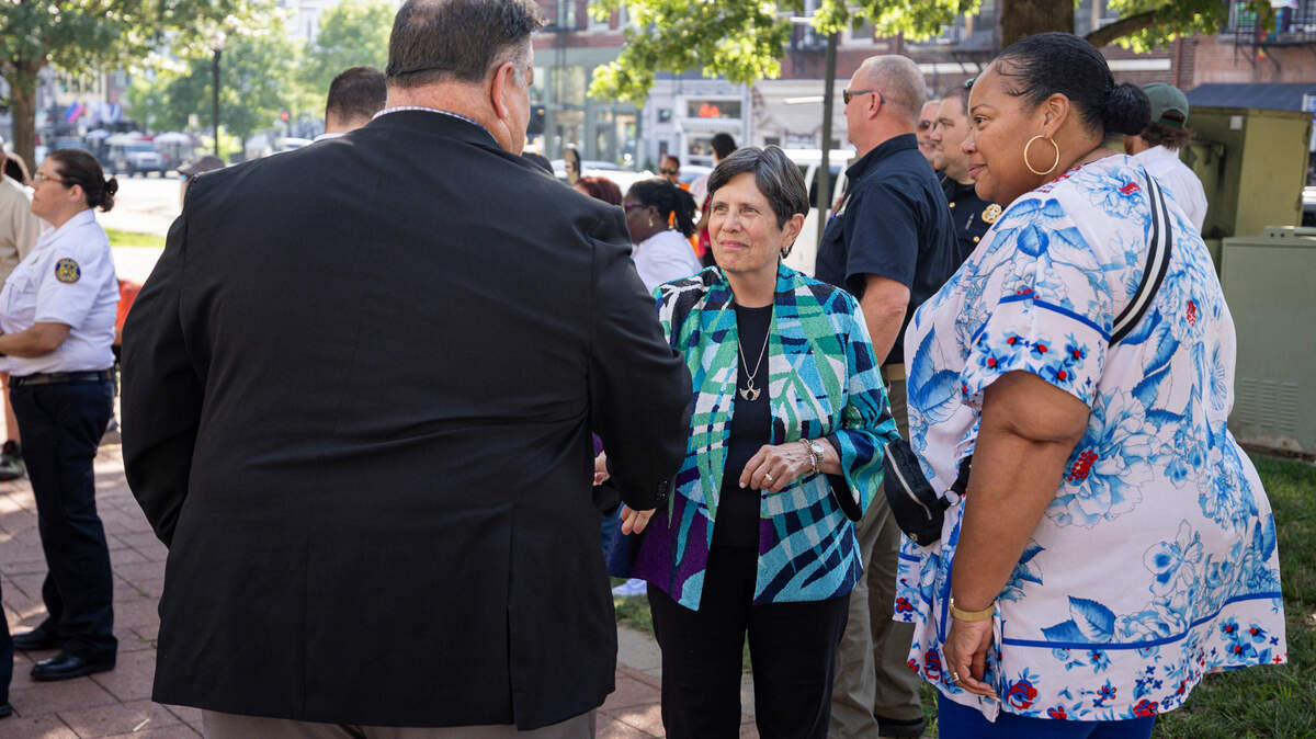 Mayor Linda Gorton, center shakes hands with Kenneth Armstrong, the comissioner of public safety in Lexington, during a community vigil on Tuesday, July 22, 2025, at Robert F. Stephens Courthouse Plaza in Lexington, Ky.
