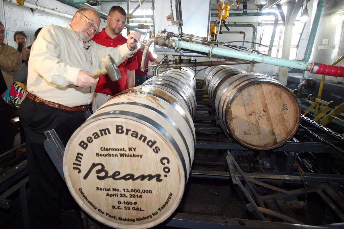 Fred Noe, left, Jim Beam’s great-grandson and seventh-generation master distiller, hammered the bung into the company’s 13 millionth barrel in April 2014 and his son, Freddie Noe, followed by hammering in the final seal.