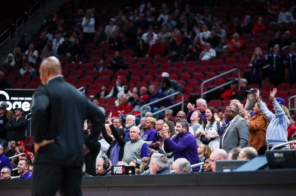 While UofL head coach Kenny Payne stands on the sideline at left, Kentucky Wesleyan fans cheer in the stands as the Panthers' free throws fell in as they took the lead late in the second half. Louisville fell to Kentucky Wesleyan, 71-68 Monday. Oct. 30, 2023.
