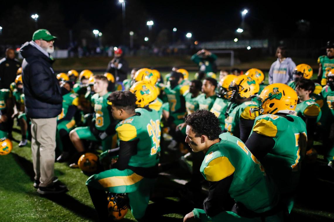 Bryan Station’s players listen to Coach Phillip Hawkins’ postgame message after the Defenders were defeated by Bullitt East in the state semifinals in Lexington on Friday night.