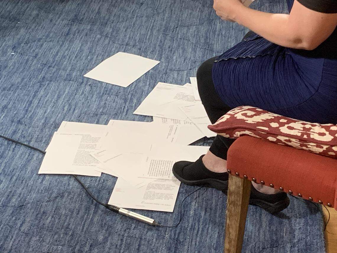 Pages of the news script at Nancy Cox’s feet. She drops the pages after she reads them.