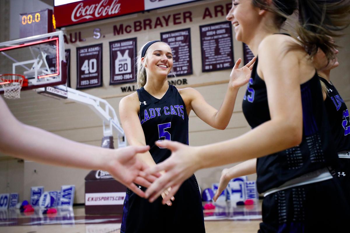 Shelby Valley’s Cassidy Rowe (5) laughed with teammates during introductions Wednesday night. Rowe, who has committed to play at the University of Kentucky, has had surgery on the ACLs in both of her knees.