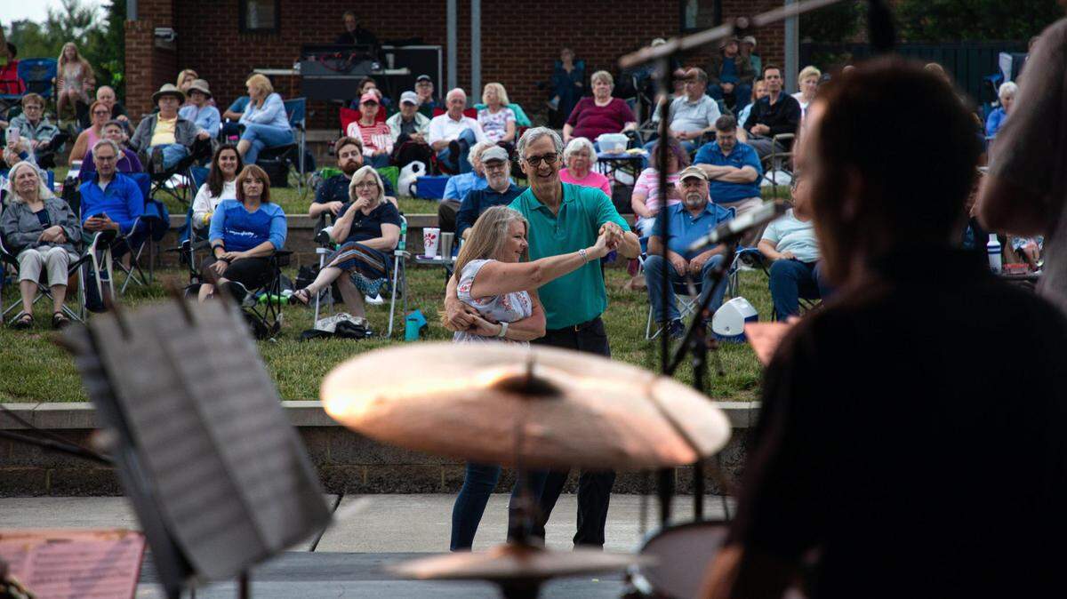 Dance partners Cindy Hellinger and David Lorio spin around in front of the stage to a number performed by The DiMartino-Osland Jazz Orchestra during a 2021 Big Band and Jazz performance at Lexington’s MoonDance Amphitheater.