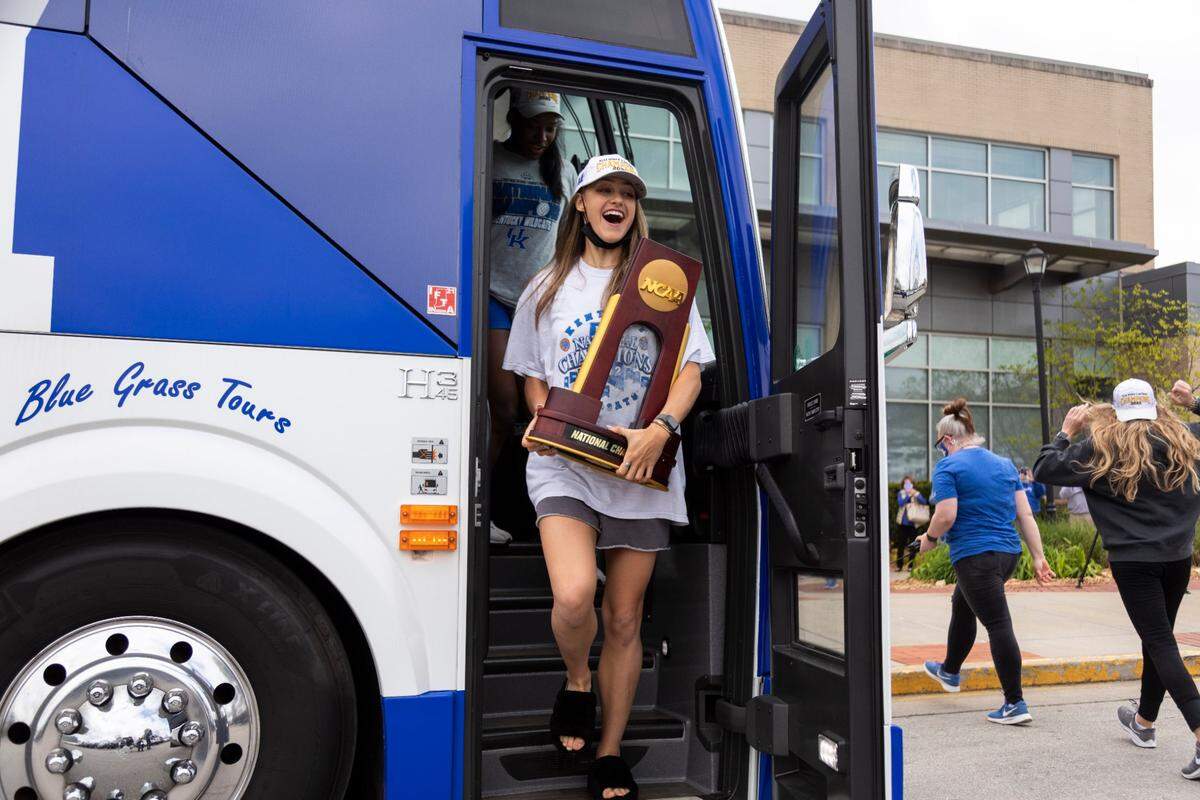 Kentucky Wildcat star setter Madison Lilley (3) held the NCAA championship trophy after Coach Craig Skinner’s Wildcats returned to Lexington after winning it all on April 25, 2021.