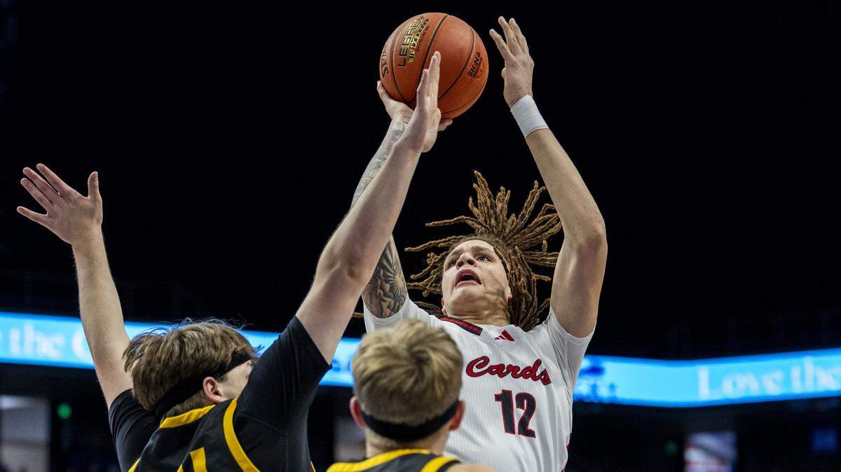 George Rogers Clark's Amari Bartelson (12) puts up a shot over Johnson Central's Ethan Cole (24), left, and Johnson Central's Austin Slone (1) during a first-round game in the 2026 UK Healthcare Boys' Basketball Sweet 16 state tournament, Thursday, March 19, 2026 at Rupp Arena in Lexington, Ky.