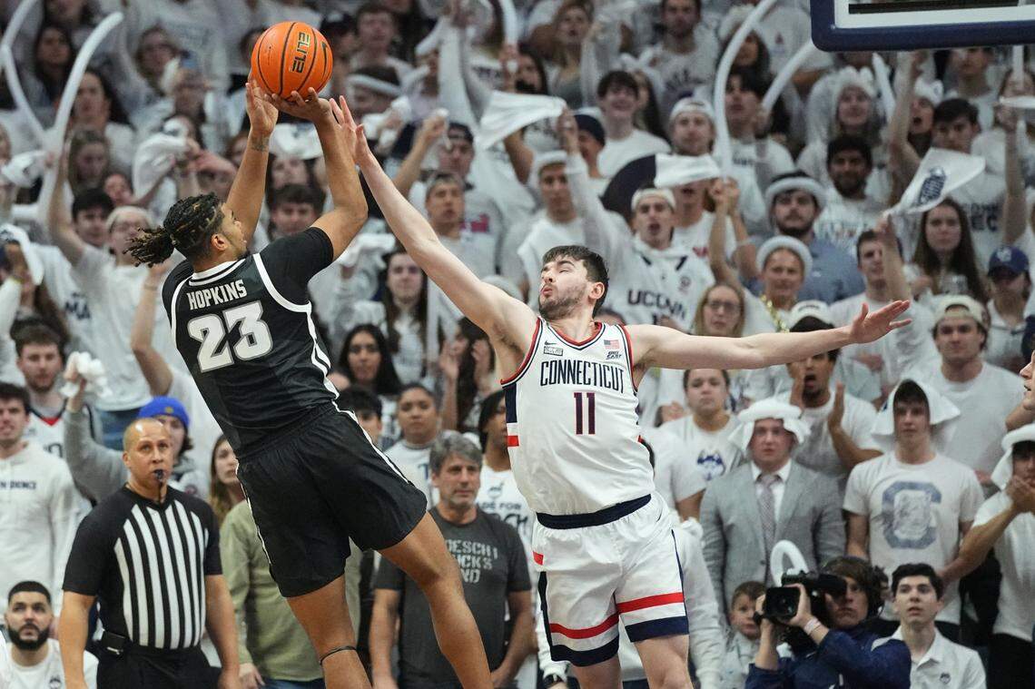 Providence forward Bryce Hopkins (23) shoots the ball against Connecticut forward Alex Karaban (11) during a game in Storrs, Conn., on Feb 22.