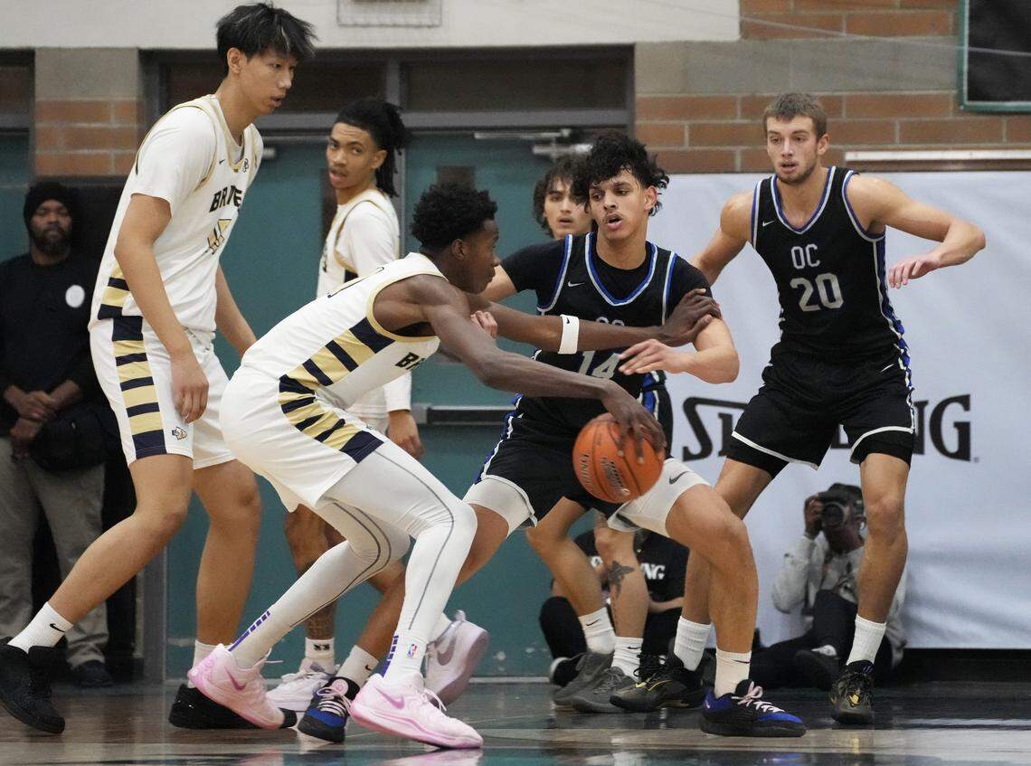 St. John Bosco's Christian Collins (11) dribbles the ball while being guarded by Sandra Day O'Connor's Colton Watson (14) during the Nike Tournament of Champions at Highland High School Gym on Jan 2, 2025, in Gilbert, Ariz.
