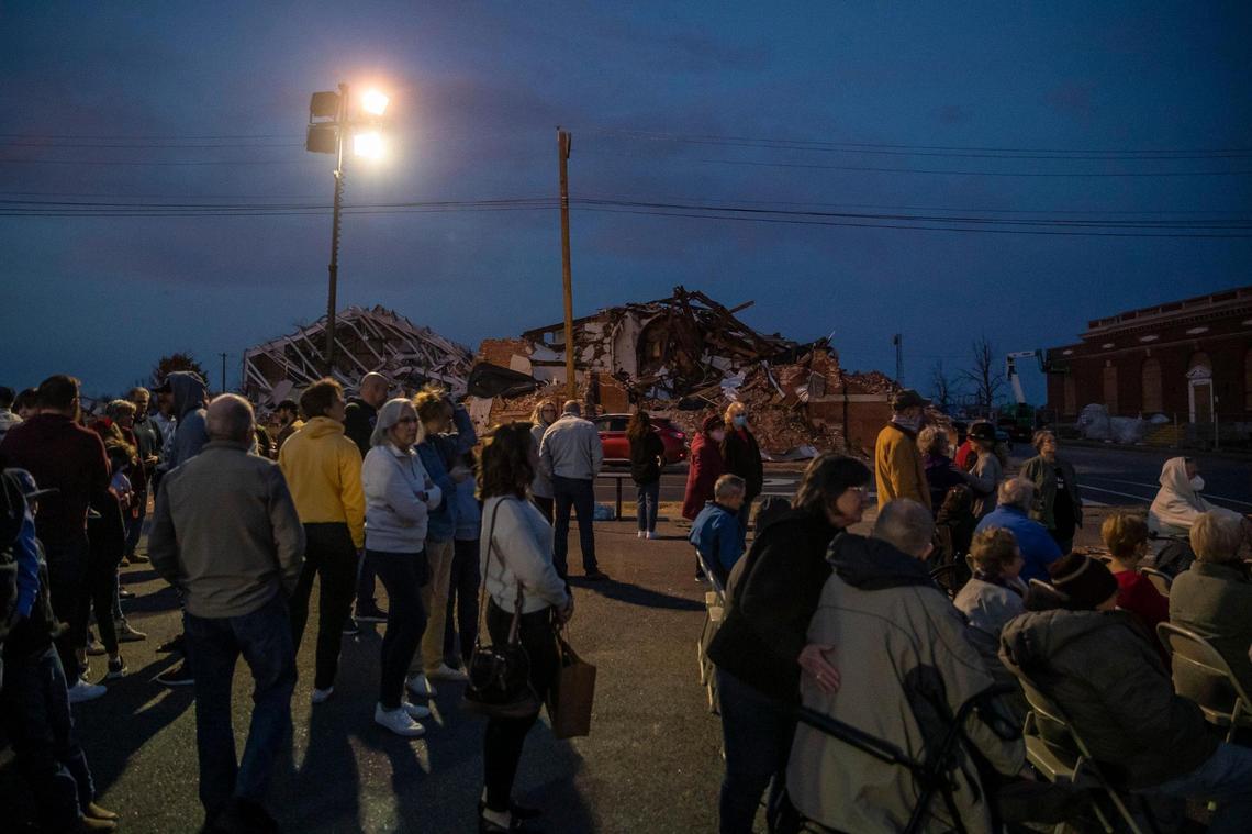 Members of Mayfield First Presbyterian Church and Mayfield First Christian Church gather in an empty lot between their destroyed church buildings for a joint Christmas Eve service in Mayfield. A tornado devastated the community on Dec. 10.